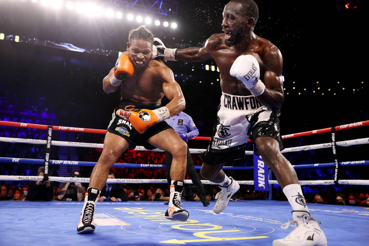 Terence Crawford, right, connects a punch against Shawn Porter in the eight round of a WBO welt ...