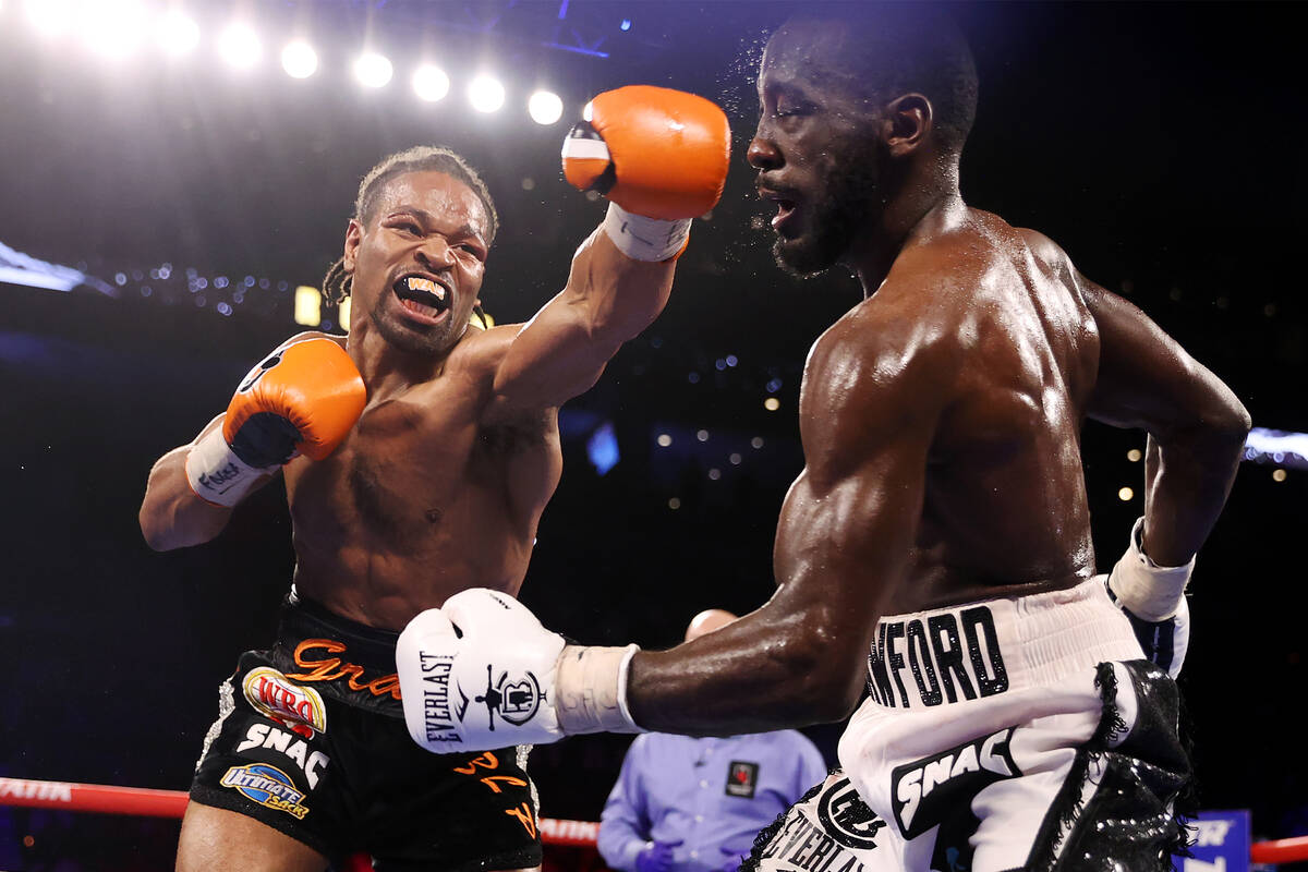 Shawn Porter, left, connects a punch against Terence Crawford in the eight round of a WBO welte ...