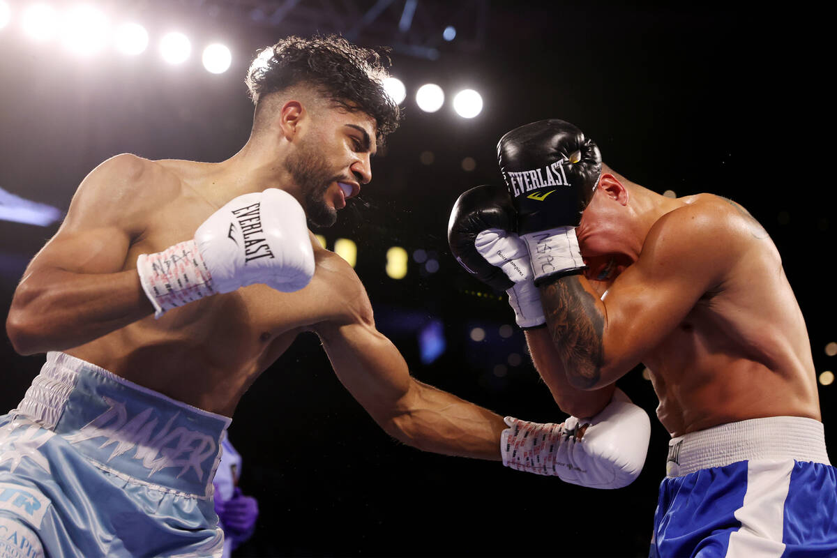Raymond Muratalla, left, connects a punch against Elias Damian Araujo in the third round of a l ...