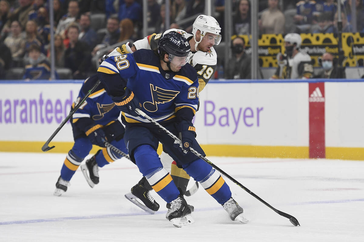 St. Louis Blues' Brandon Saad (20) and Vegas Golden Knights' Reilly Smith (19) vie for the puck ...