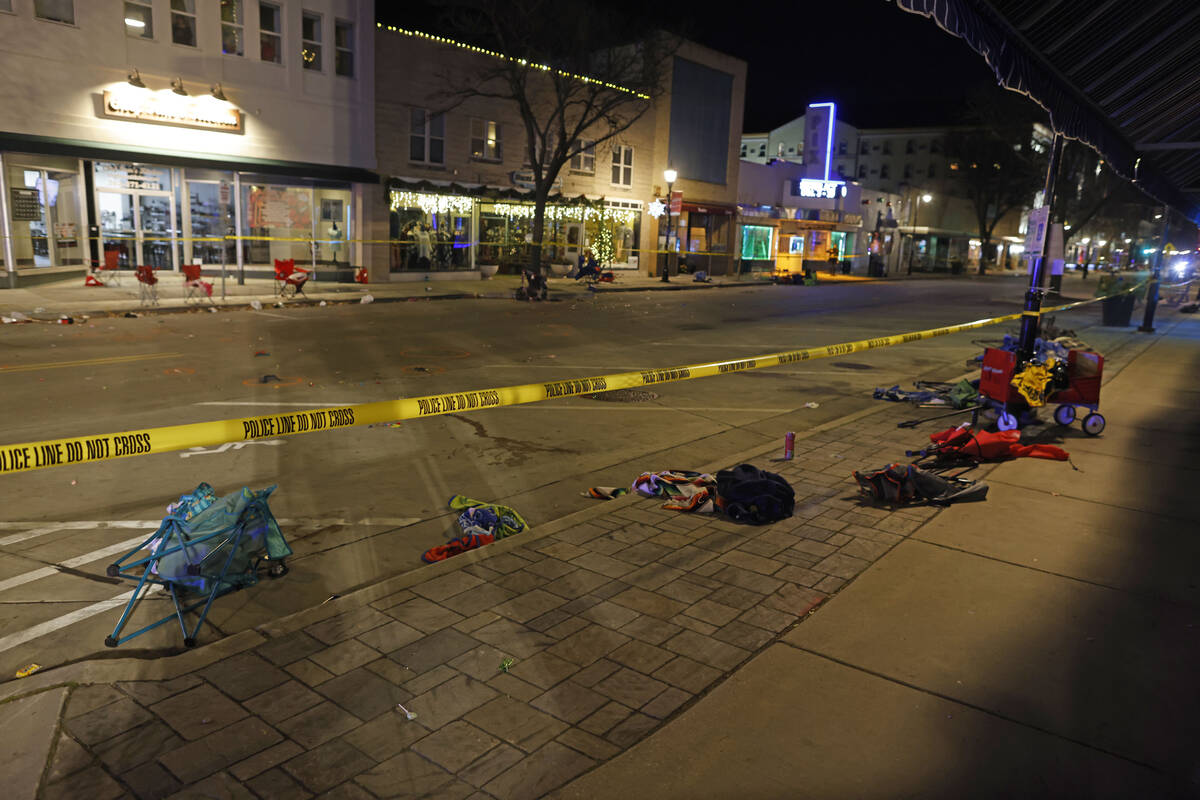 Police tape cordons off a street in Waukesha, Wis., after a vehicle plowed into a Christmas par ...