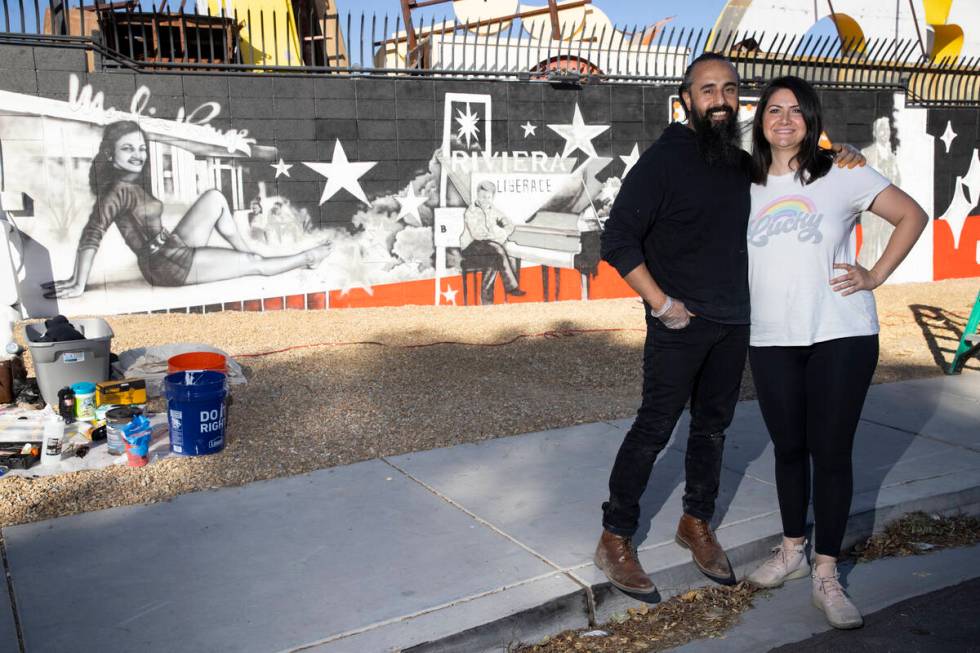 Ali Fathollahi, left, and wife Nanda Sharifpour pose for a portrait in front of a mural they ar ...