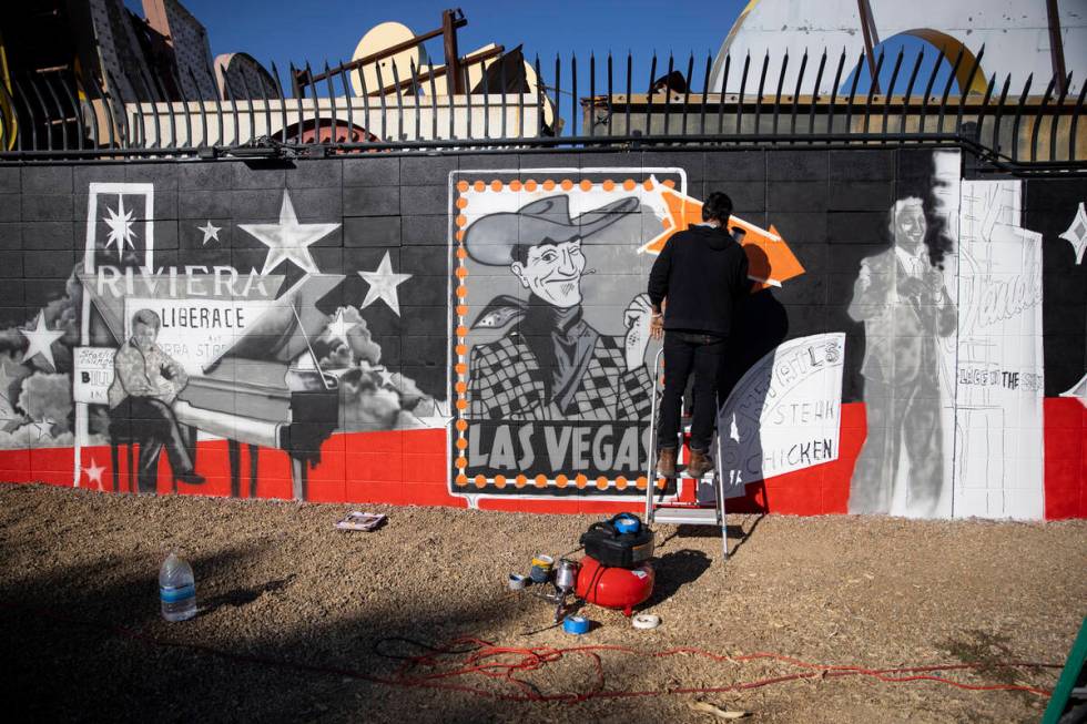 Ali Fathollahi works on a mural outside of the Neon Museum North Gallery in Las Vegas, Tuesday, ...