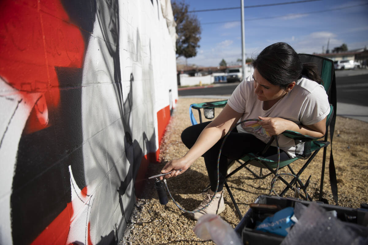 Nanda Sharifpour works on a mural outside of the Neon Museum North Gallery in Las Vegas, Tuesda ...