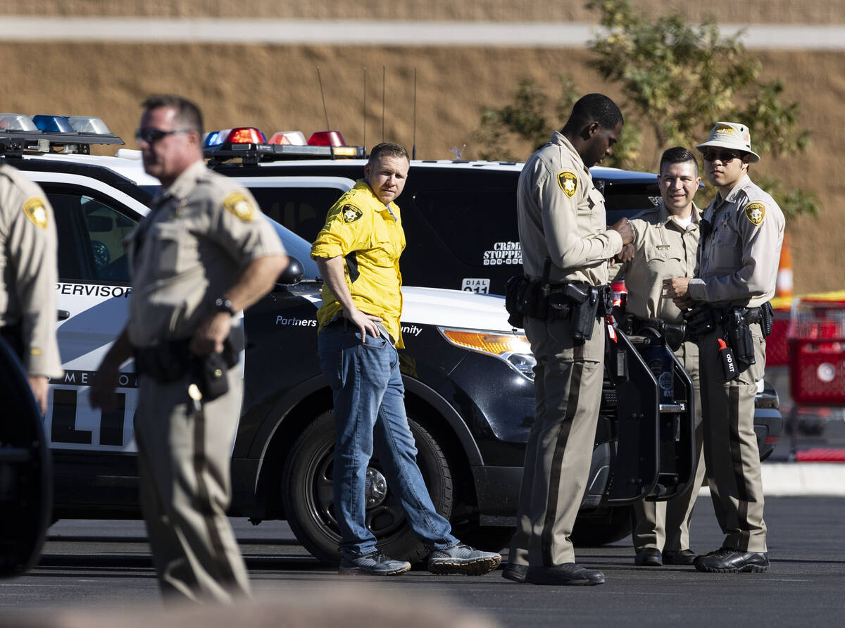 Las Vegas police officers investigate an officer-involved shooting at 3200 Tenaya Way, on Wedne ...