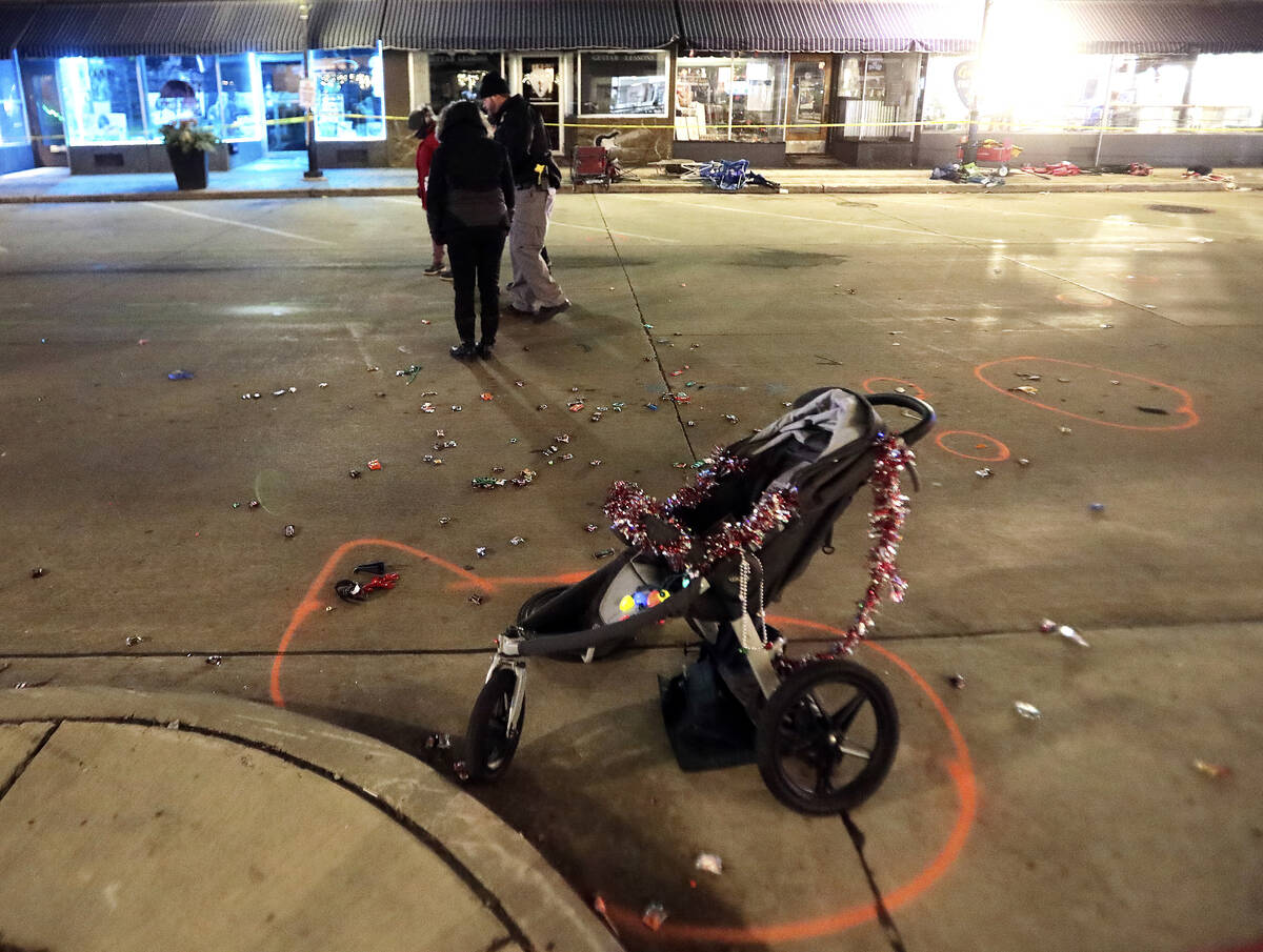 A broken children's stroller lays on West Main Street in downtown Waukesha, Wis., after an SUV ...