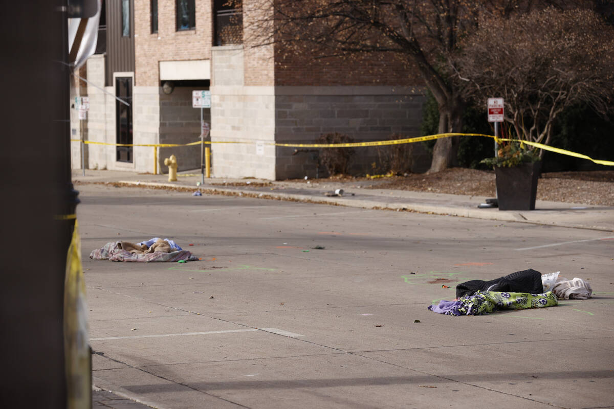 Items lie in the middle of a street in Waukesha, Wis., Monday, Nov. 22. 2021, where investigati ...