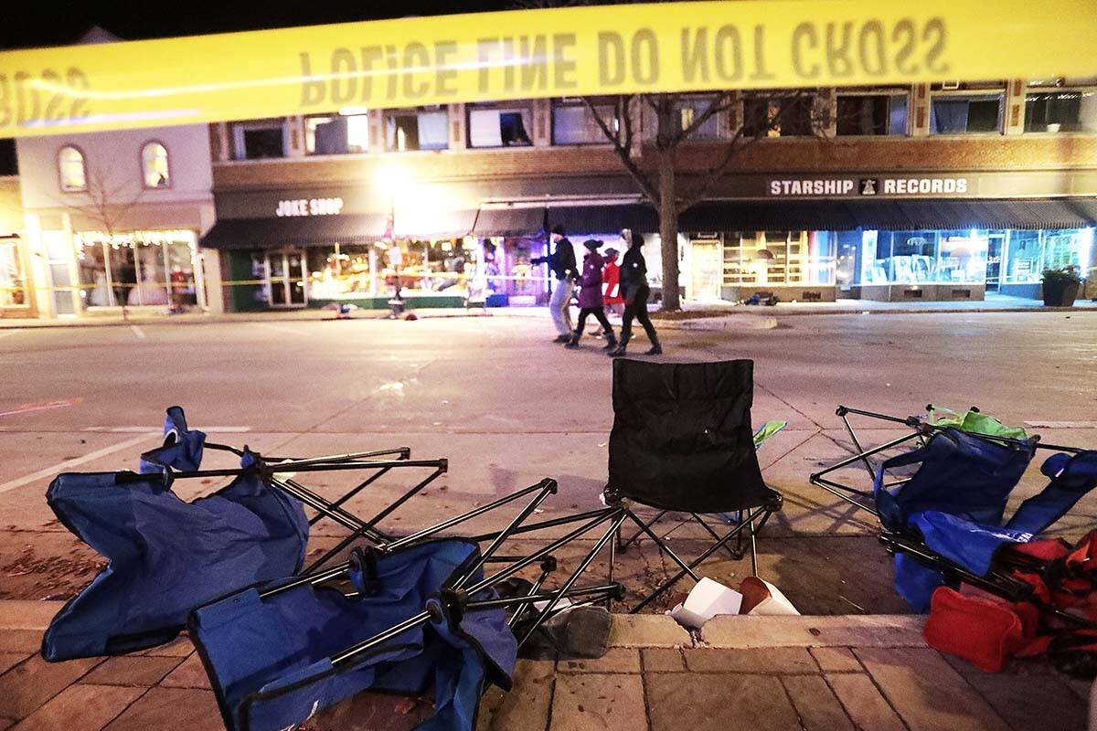 Toppled chairs line West Main Street in downtown Waukesha, Wis., after an SUV drove into a para ...