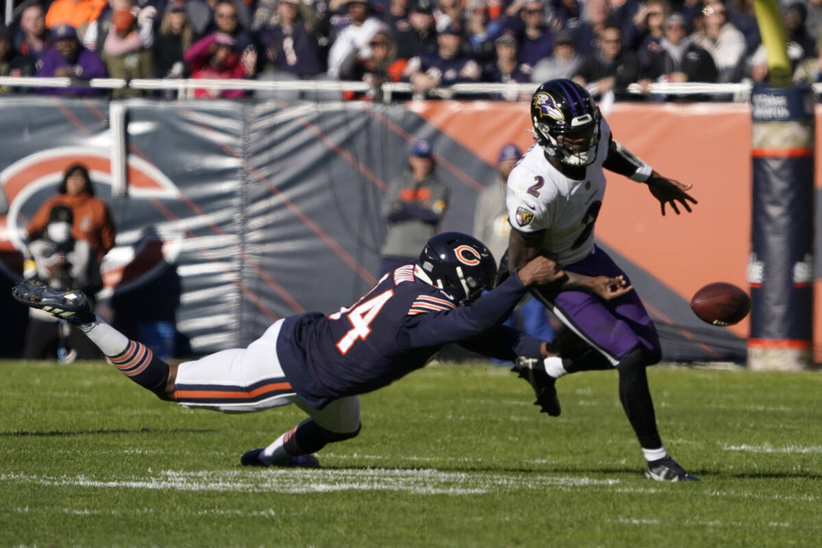 Chicago Bears outside linebacker Robert Quinn strips the ball from Baltimore Ravens quarterback ...