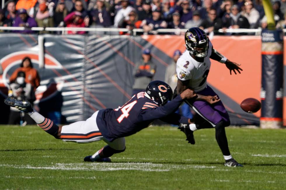 Chicago Bears outside linebacker Robert Quinn strips the ball from Baltimore Ravens quarterback ...