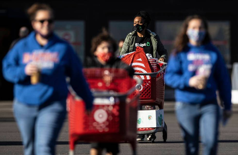 Shoppers walk to their cars on Black Friday at TargetÕs 4155 S Grand Canyon Dr. location o ...