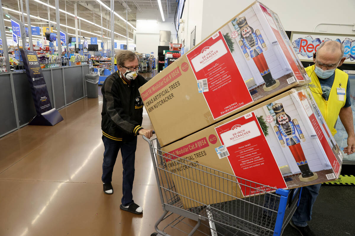 Robert Sachetti, 60, of Las Vegas, rolls out his purchases shortly after the 5 a.m. opening at ...