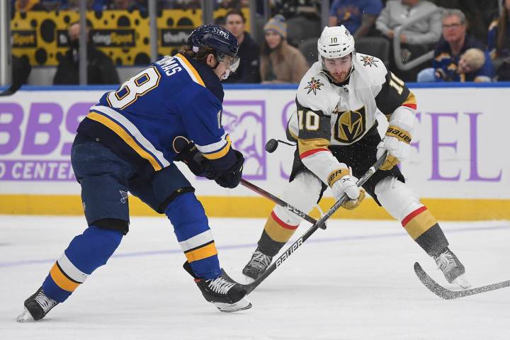 Vegas Golden Knights' Nicolas Roy (10) and St. Louis Blues' Robert Thomas (18) vie for the puck ...