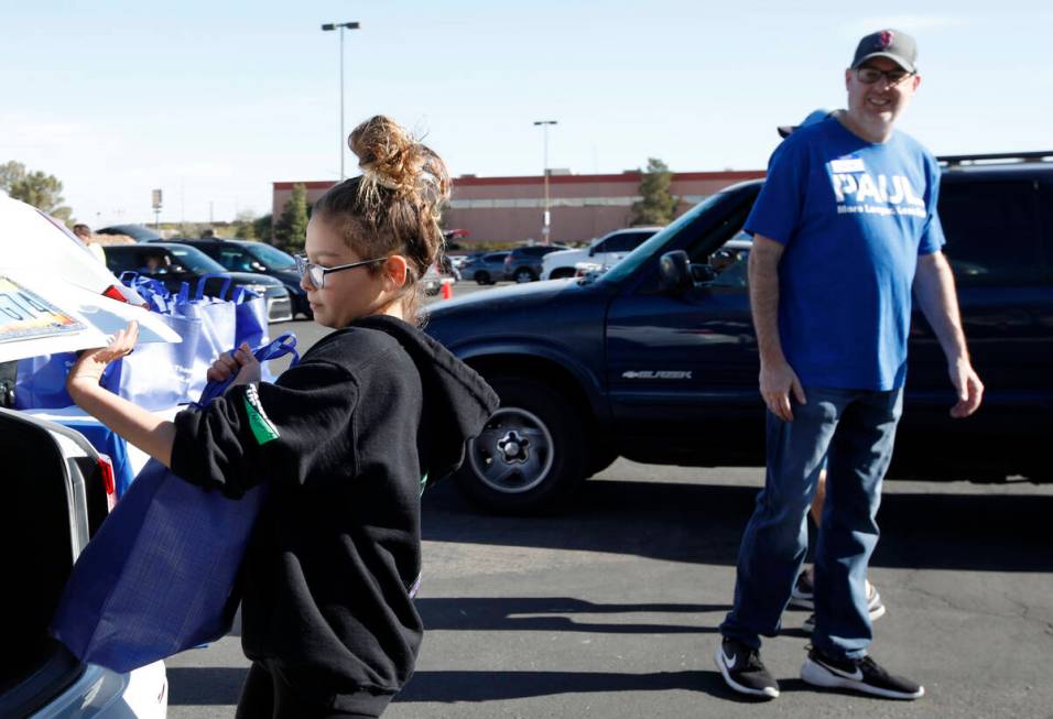 Gianna Marcolongo, 12, of Las Vegas helps to give away turkeys during Paul Powell's annual Than ...