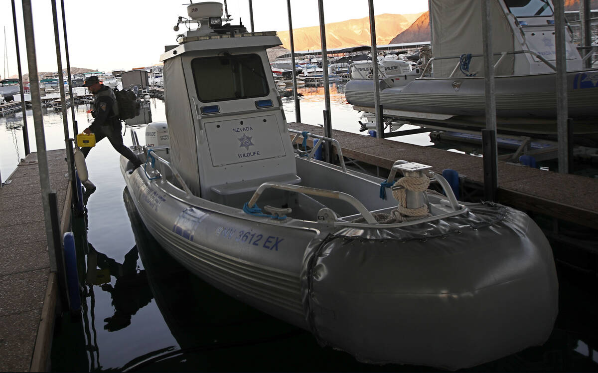 Sean Flynn, Nevada Department of Wildlife game warden, leaves a boat after he patrolled Lake Me ...