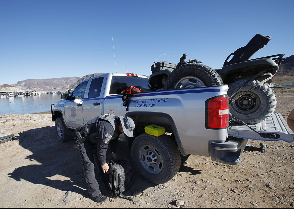 Sean Flynn, Nevada Department of Wildlife game warden, prepares for patrolling Lake Mead near o ...