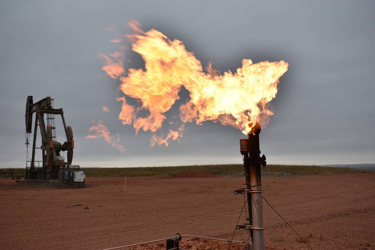 A flare burns natural gas at an oil well on Aug. 26, 2021, in Watford City, N.D. (AP Photo/Matt ...