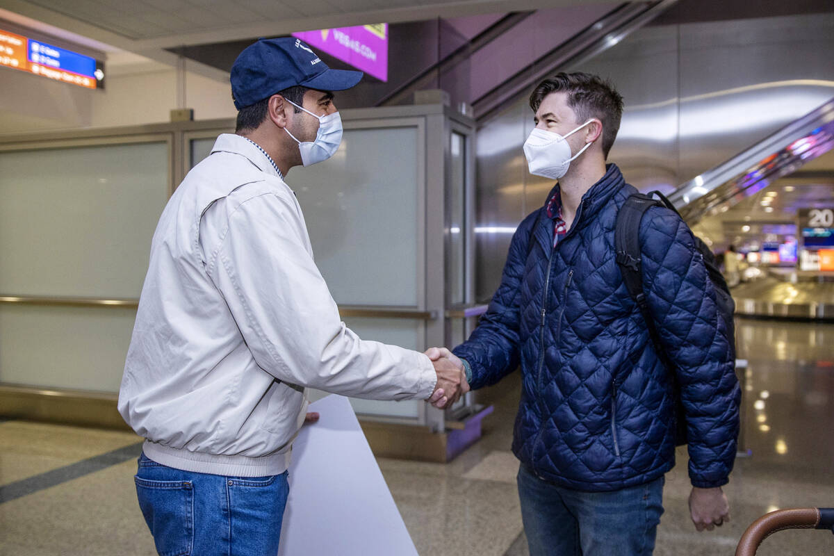 Afghan evacuee Benny, left, greets pilot Christopher Hoffman at McCarran International Airport ...