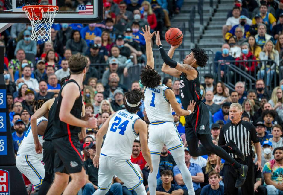 Gonzaga guard Julian Strawther (0) goes up for a shot over UCLA guard Jules Bernard (1) during ...