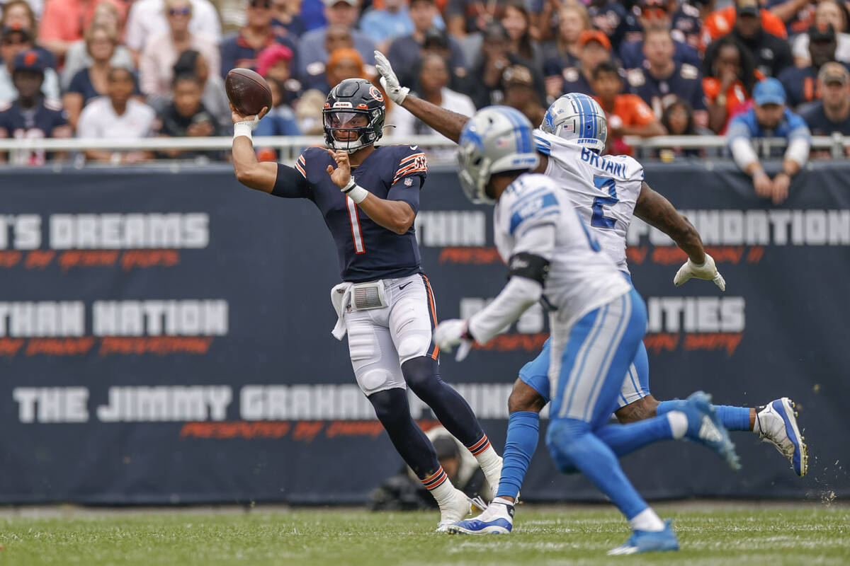 Chicago Bears quarterback Justin Fields (1) passes the ball against the Detroit Lions during th ...