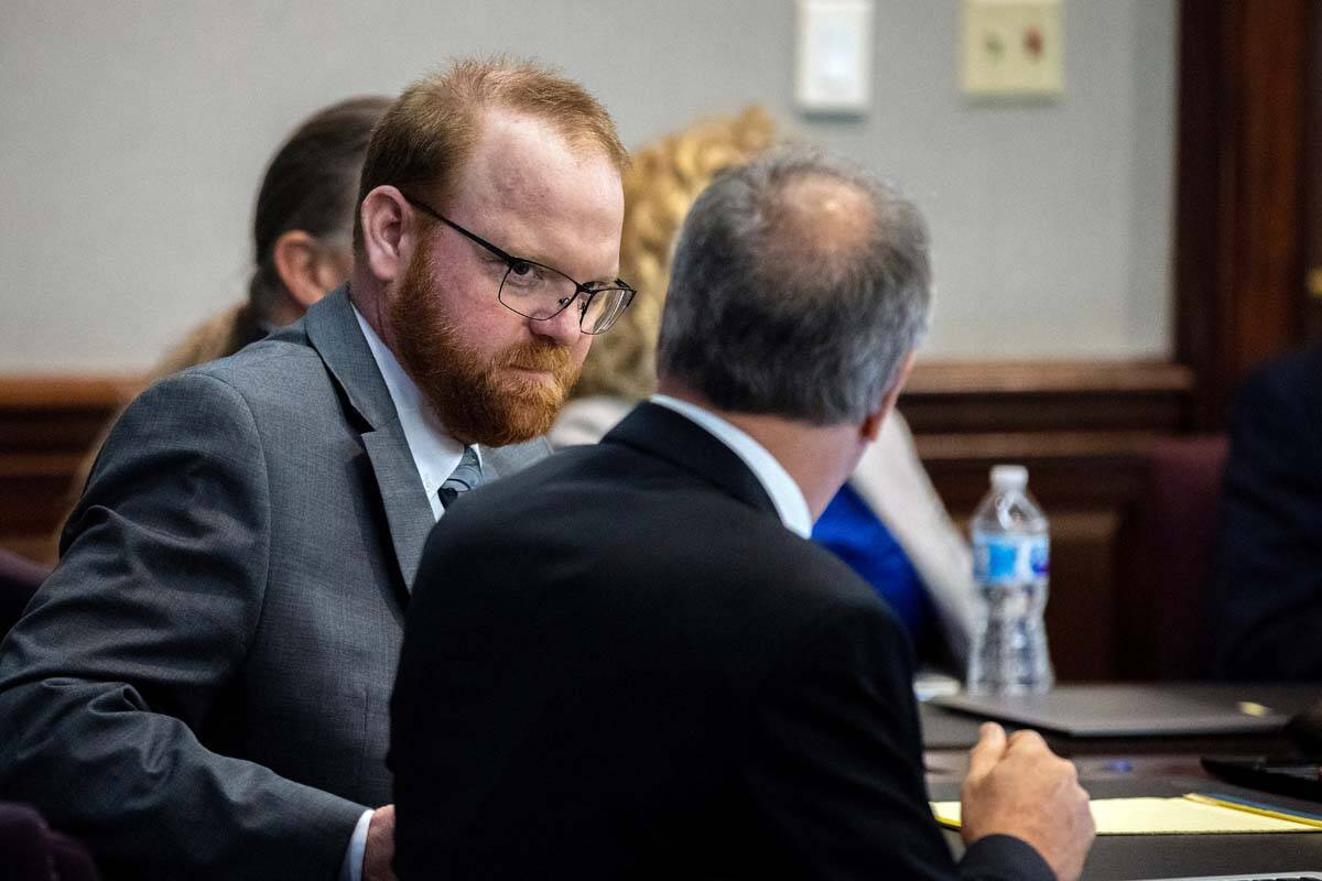 Defendant Travis McMichael speaks with his attorney Bob Rubin while they wait for the jury to r ...