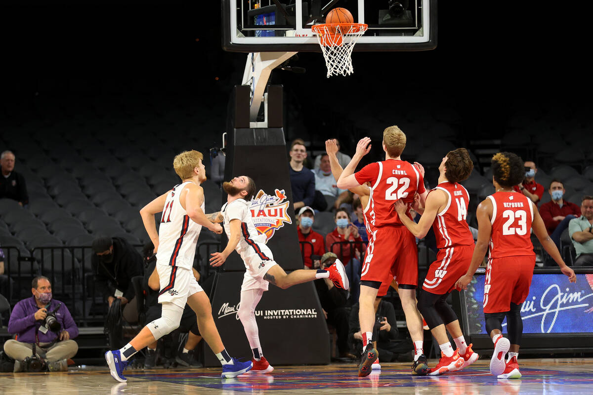 St. Mary's Gaels guard Logan Johnson (0) makes a basket under pressure from Wisconsin Badgers f ...