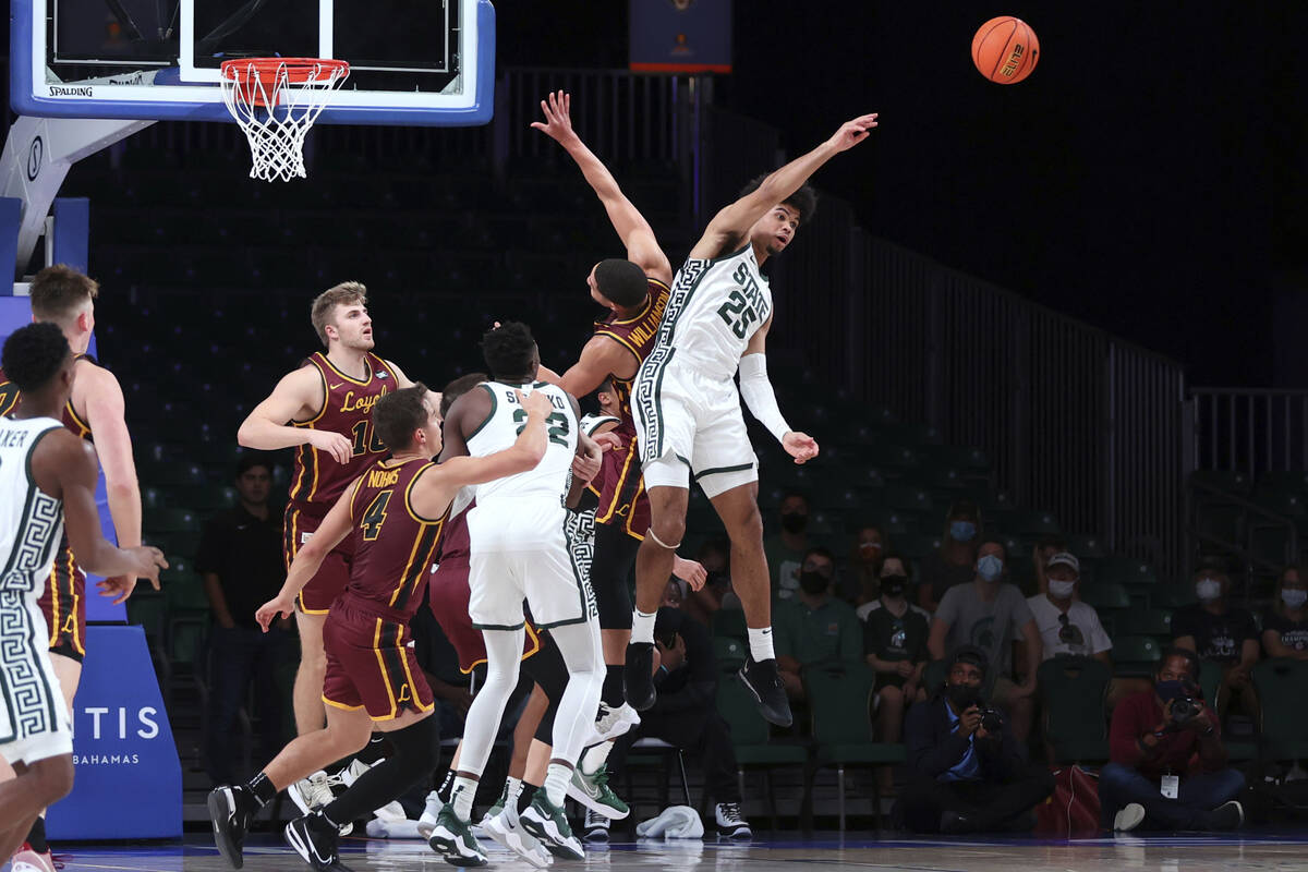 In a photo provided by Bahamas Visual Services, Michigan State forward Malik Hall (25) vies for ...