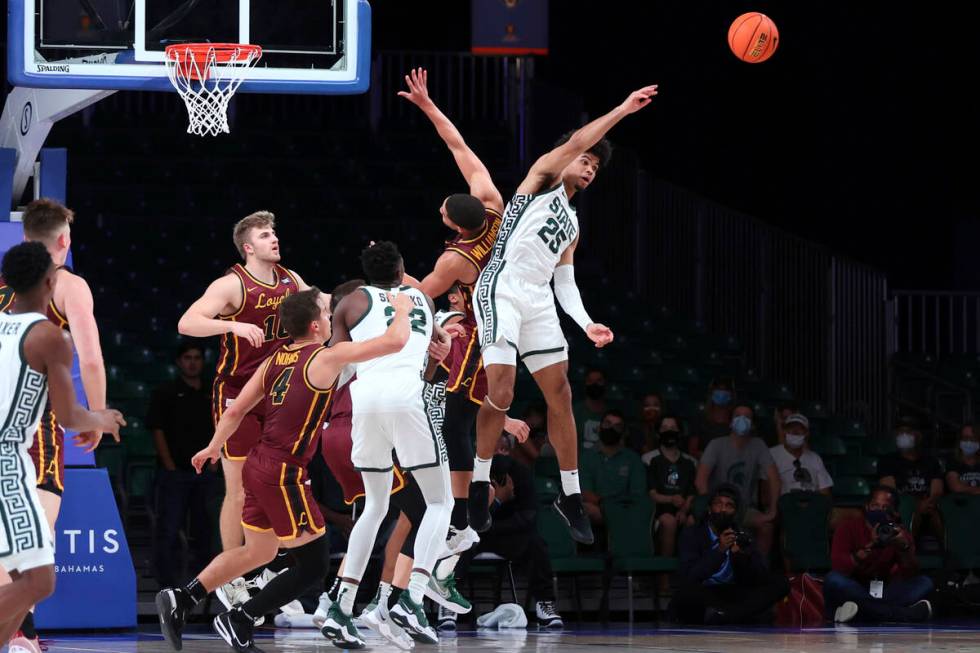 In a photo provided by Bahamas Visual Services, Michigan State forward Malik Hall (25) vies for ...