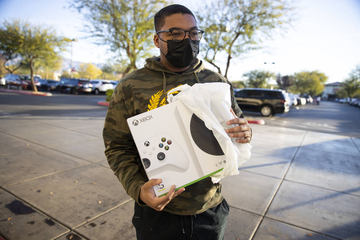 A.J. Plummer of Las Vegas holds an Xbox Series S he bought during Black Friday shopping at Targ ...