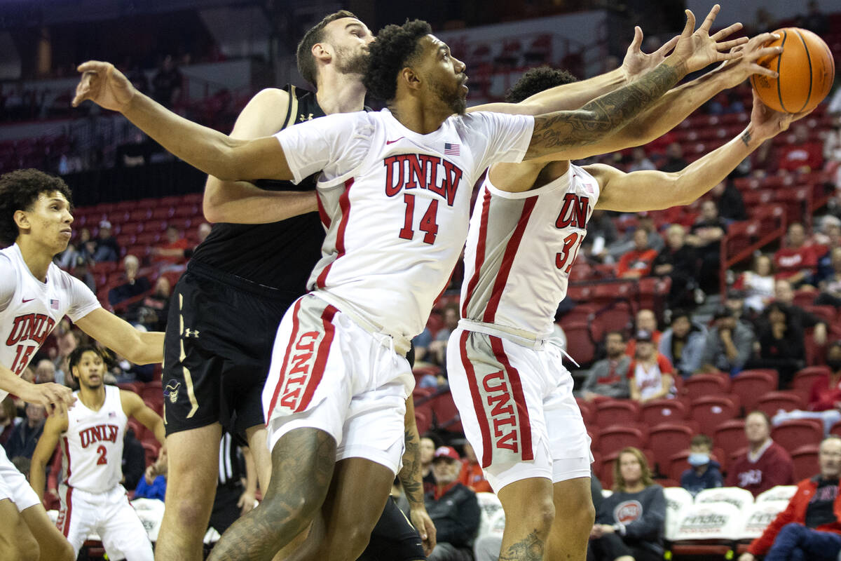 UNLV Rebels forward Royce Hamm Jr. (14) and guard Marvin Coleman (31) recover an attempted shot ...