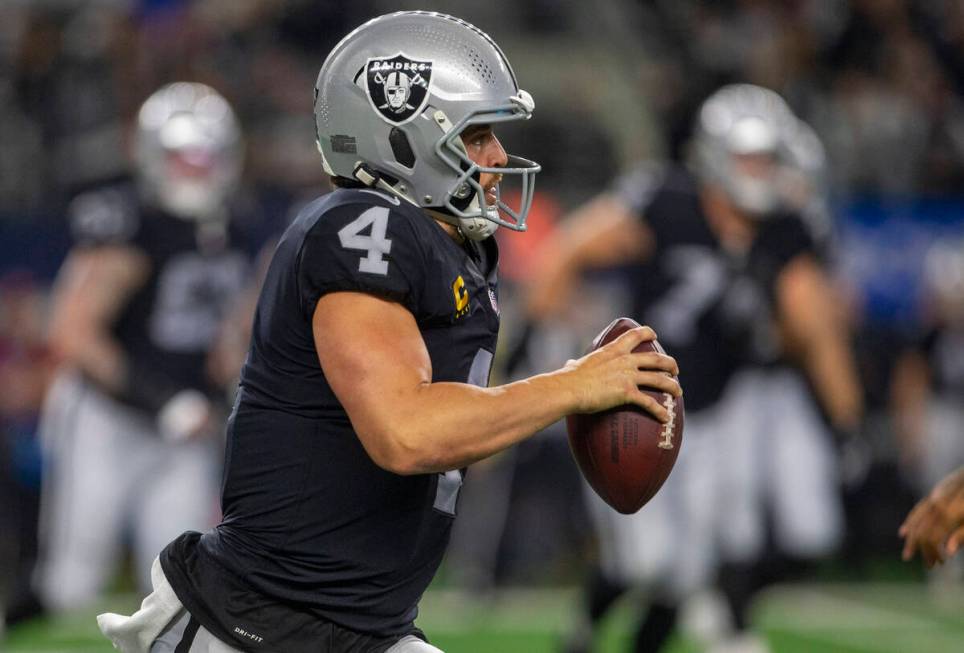 Raiders quarterback Derek Carr (4) runs with the football during the fourth quarter of an NFL f ...