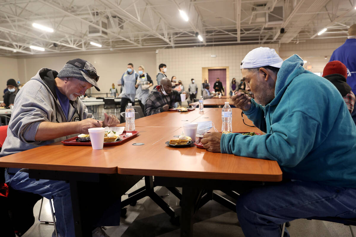 Gary Nichols, 61, left, and Leo Nino, 58, eat a free Thanksgiving meal in the renovated St. Vin ...