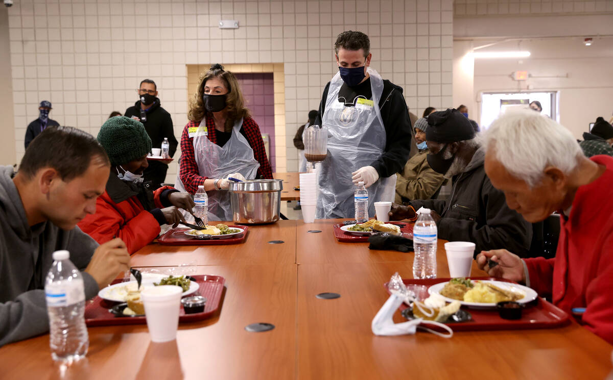 Shelley Berkley and her son Max Berkley serve hot chocolate during a free Thanksgiving meal in ...