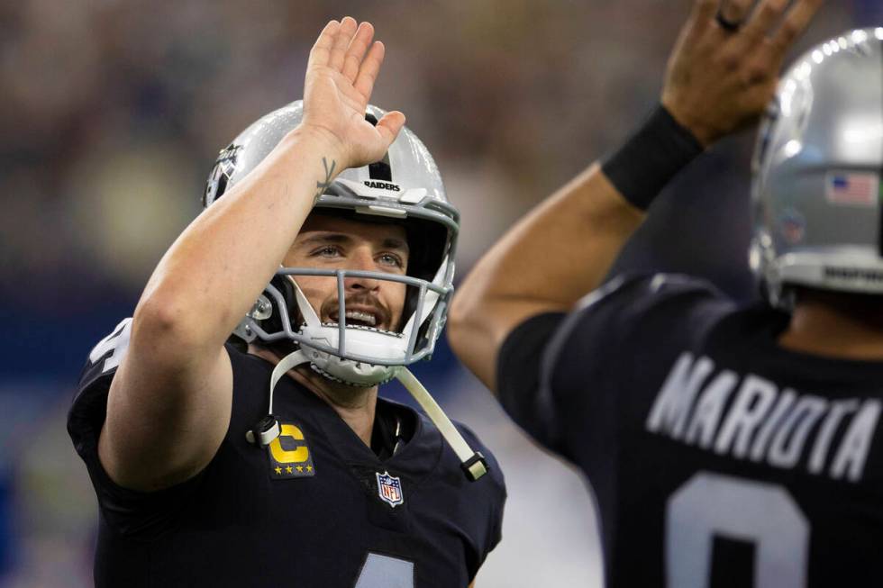 Raiders quarterback Derek Carr (4) celebrates a first half touchdown with Raiders quarterback M ...