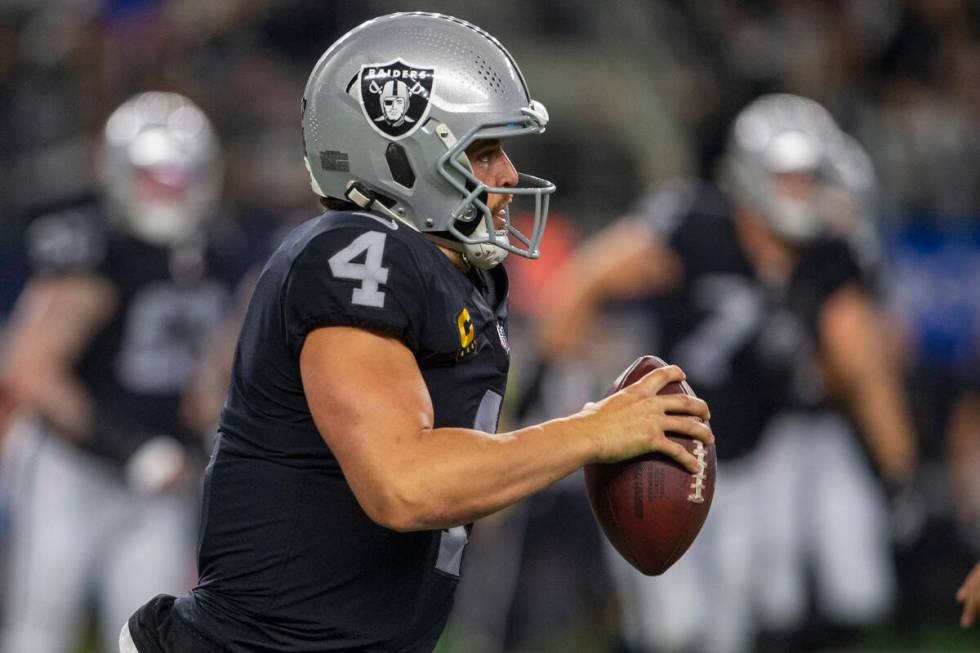 Raiders quarterback Derek Carr (4) runs with the football during the fourth quarter of an NFL f ...