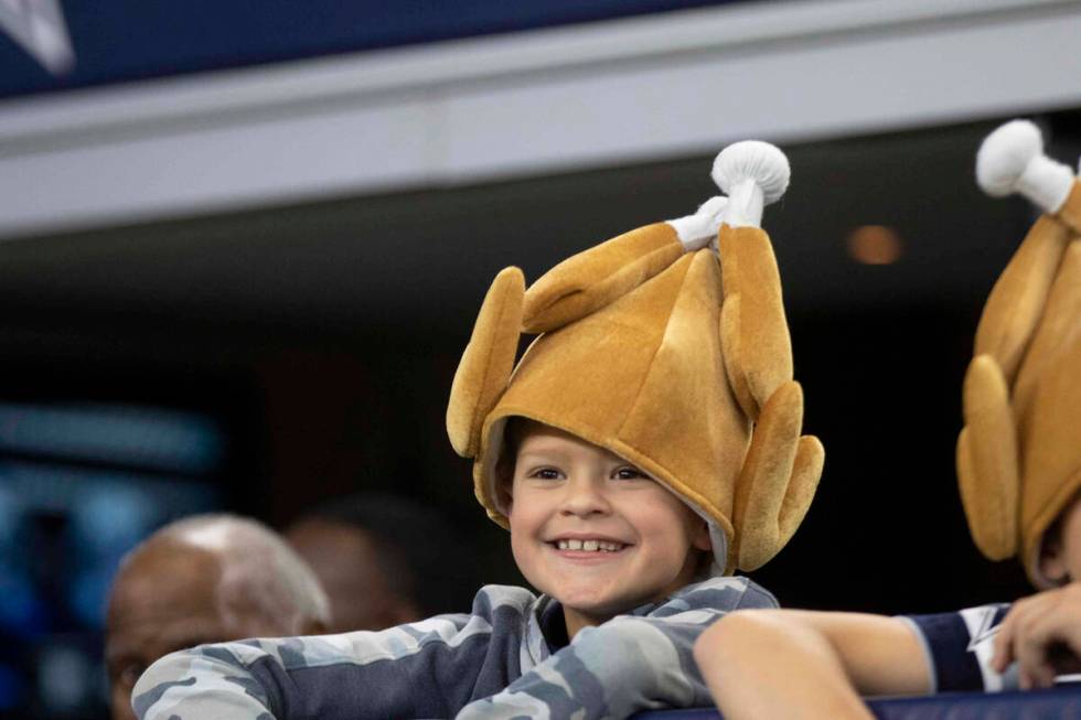 A Dallas Cowboys fan wears a turkey hat before an NFL football game against the Raiders on Thur ...