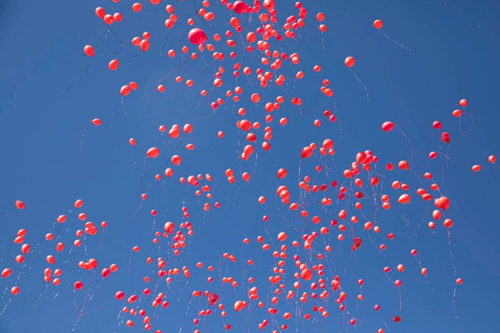 Biodegradable balloons are released during a vigil to the late Kenny Lee, the heir to Lee&#x573 ...