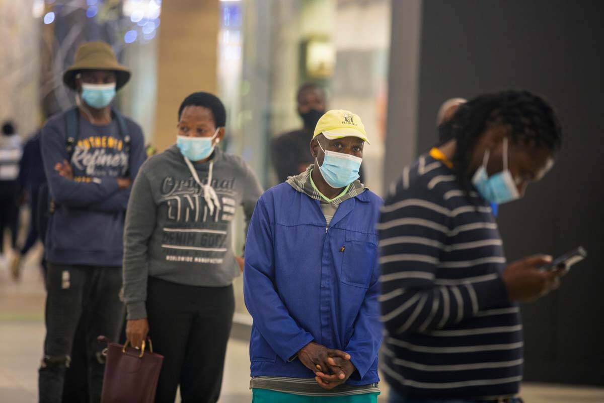 People queue to get vaccinated at a shopping mall, in Johannesburg, South Africa, Friday Nov. 2 ...