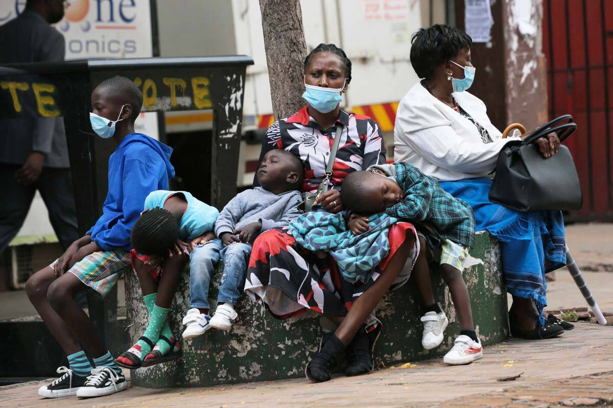 A mother takes time to rest with her children in Harare, Zimbabwe, Friday, Nov, 26, 2021. A sle ...
