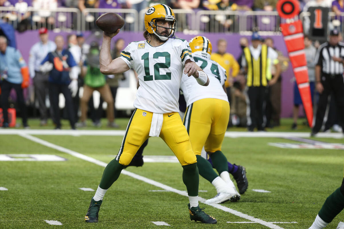 Green Bay Packers quarterback Aaron Rodgers (12) throws a pass during the first half of an NFL ...