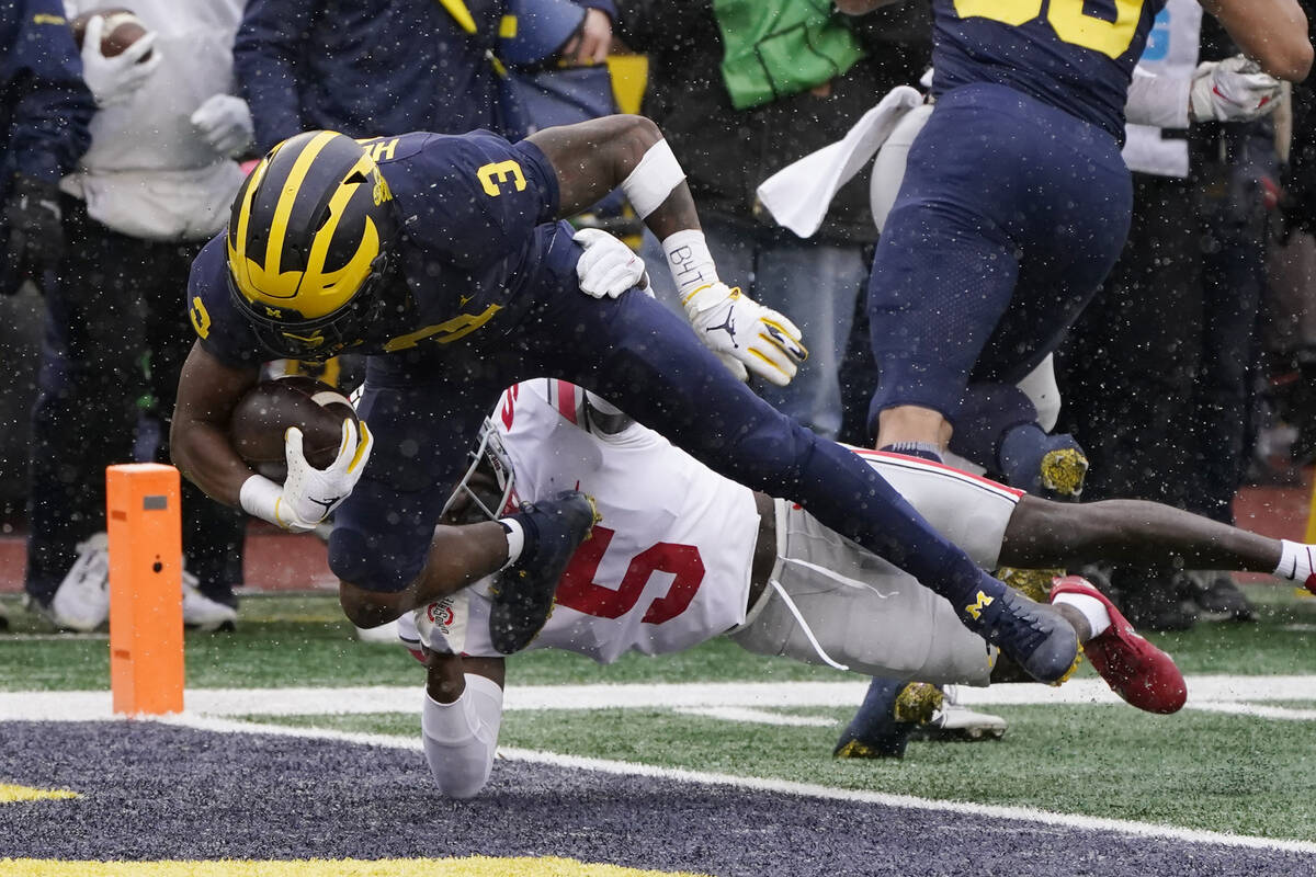 Michigan wide receiver A.J. Henning (3) falls into the end zone for a touchdown as Ohio State c ...