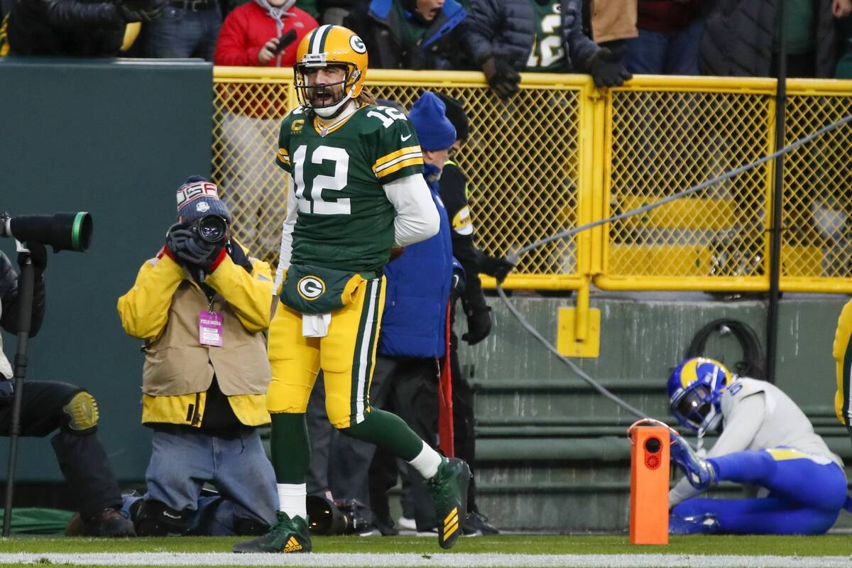 Green Bay Packers' Aaron Rodgers reacts after running for a touchdown during the first half of ...