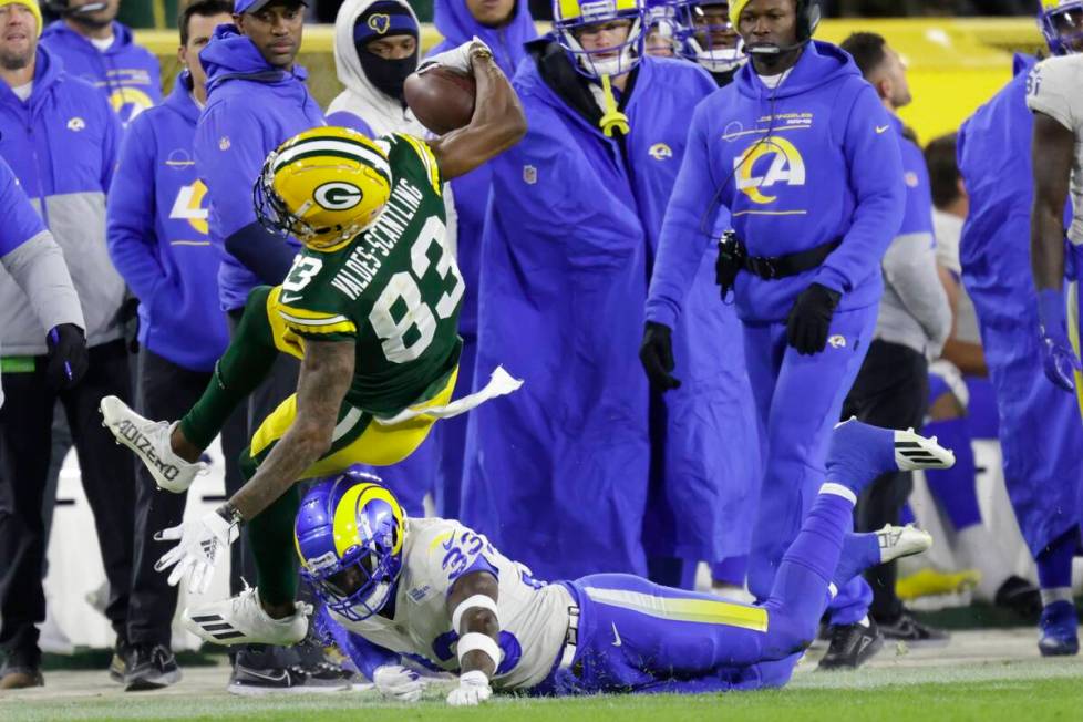 Los Angeles Rams' Nick Scott stops Green Bay Packers' Marquez Valdes-Scantling during the secon ...