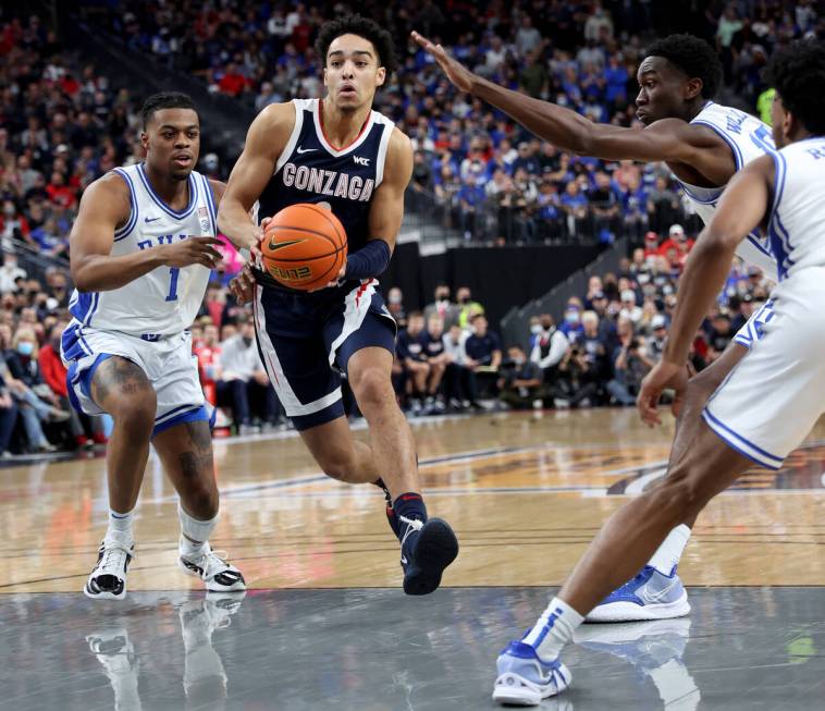 Gonzaga Bulldogs guard Julian Strawther (0) drives past Duke Blue Devils guard Trevor Keels (1) ...