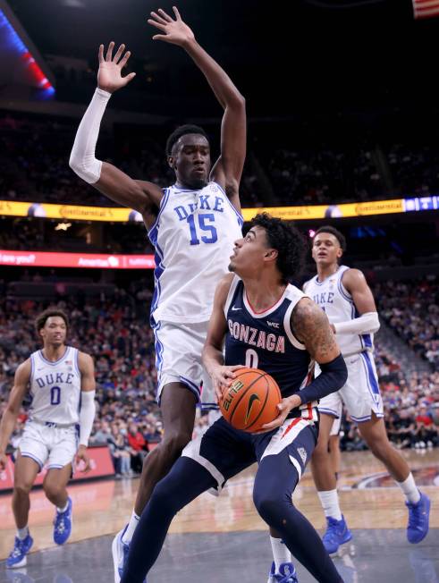 Gonzaga Bulldogs guard Julian Strawther (0) looks to shoot past Duke Blue Devils center Mark Wi ...