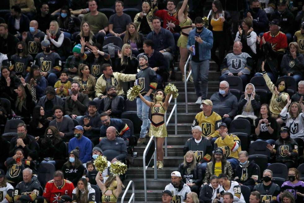 A Golden Knights cheerleader cheers during the third period of an NHL hockey game at T-Mobile A ...