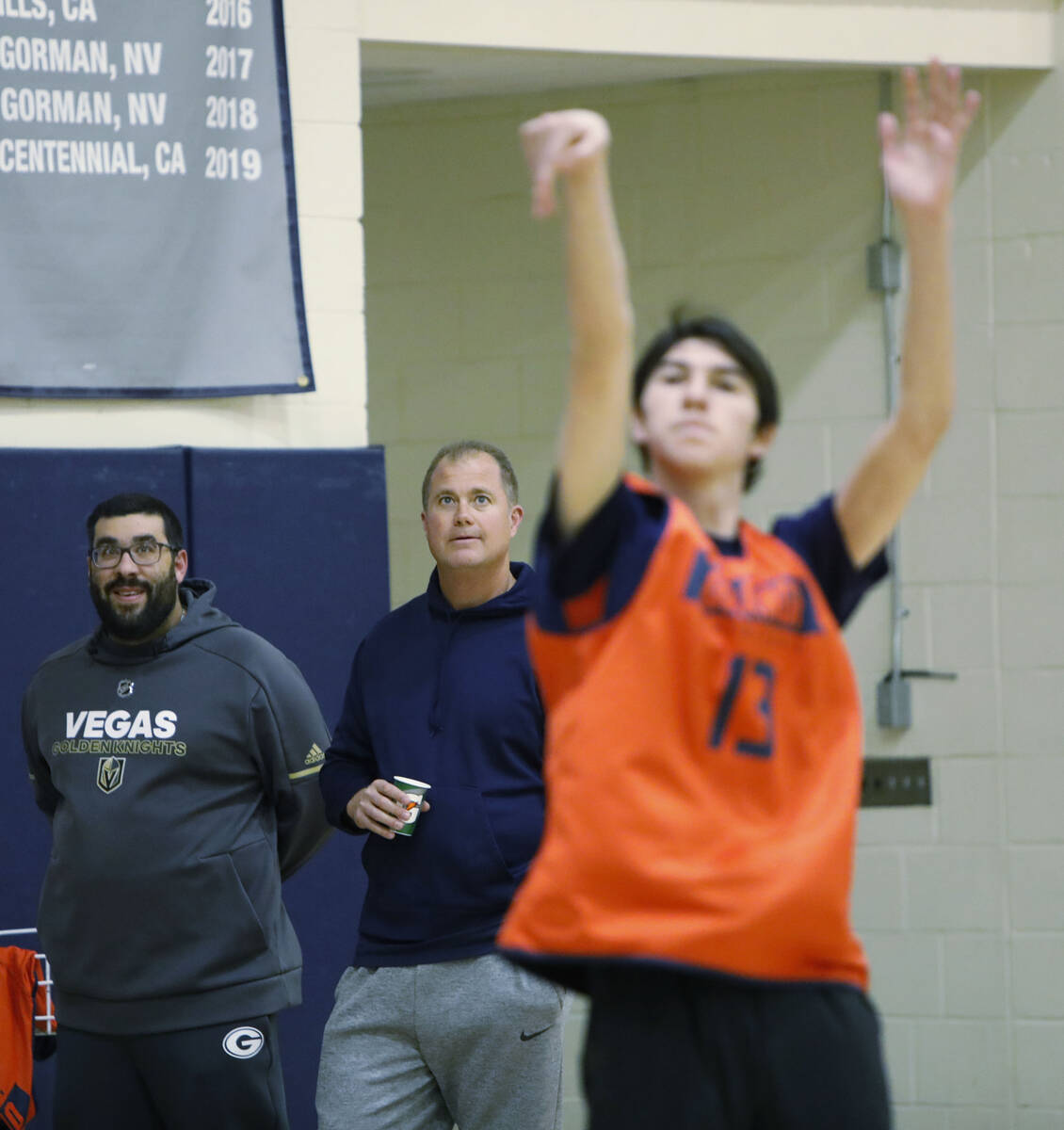 Bishop Gorman basketball head coach Grant Rice, center, and assistant coach Jimmy Gleich, left, ...
