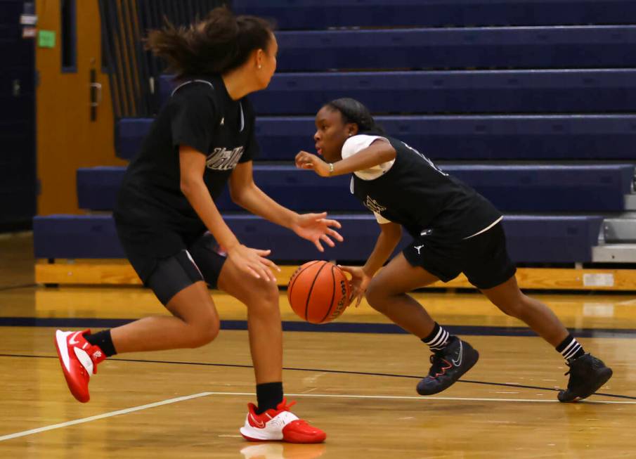 Spring Valley's Kiara Williams, right, drives to the basket under pressure from Gia McFadden du ...