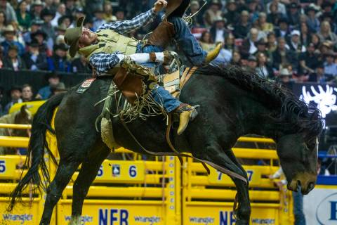 Ty Breuer of Mandan, N.D., rides Prairie Rose during Bareback Riding in the seventh go round of ...