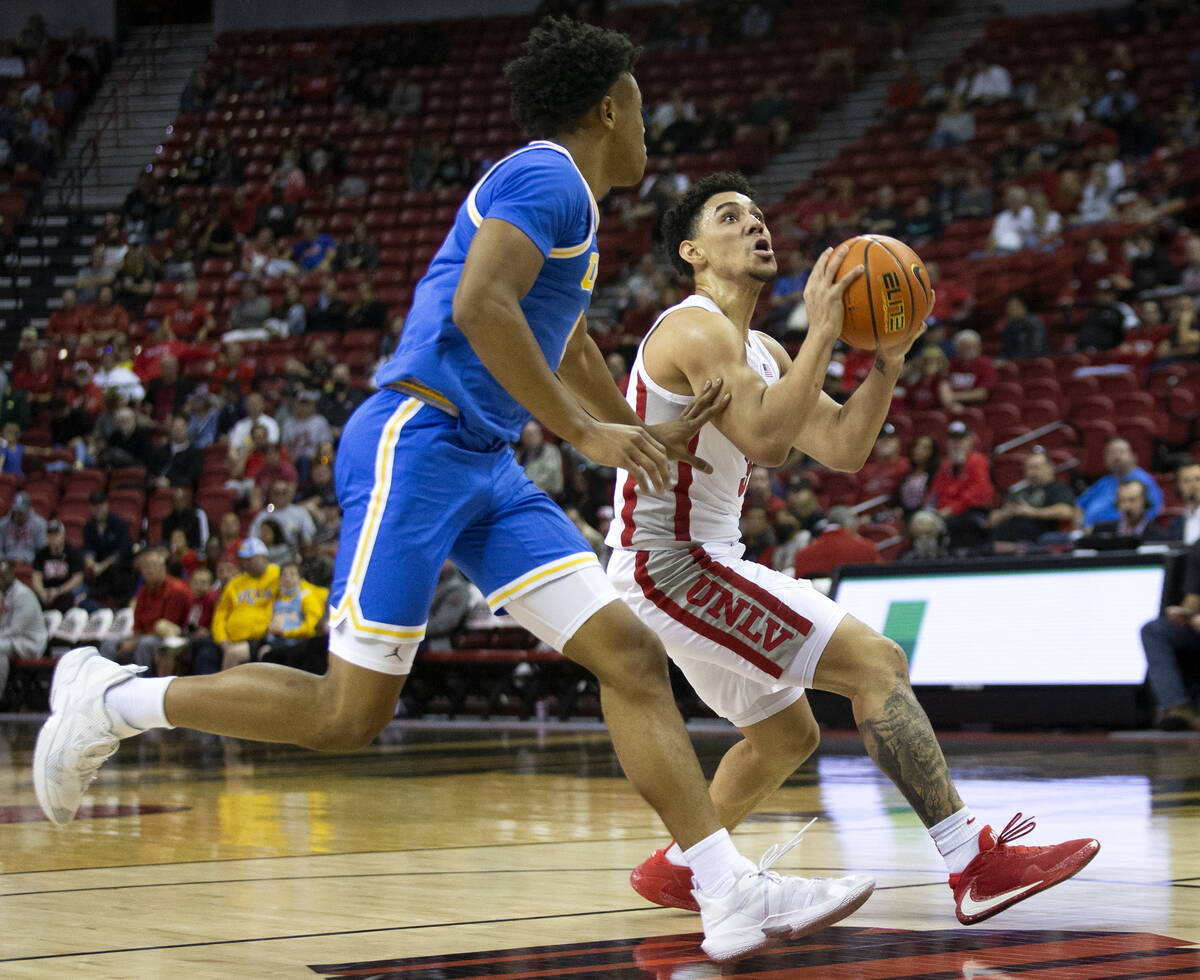 UNLV Rebels guard Marvin Coleman (31) drives up the court while UCLA Bruins guard Peyton Watson ...